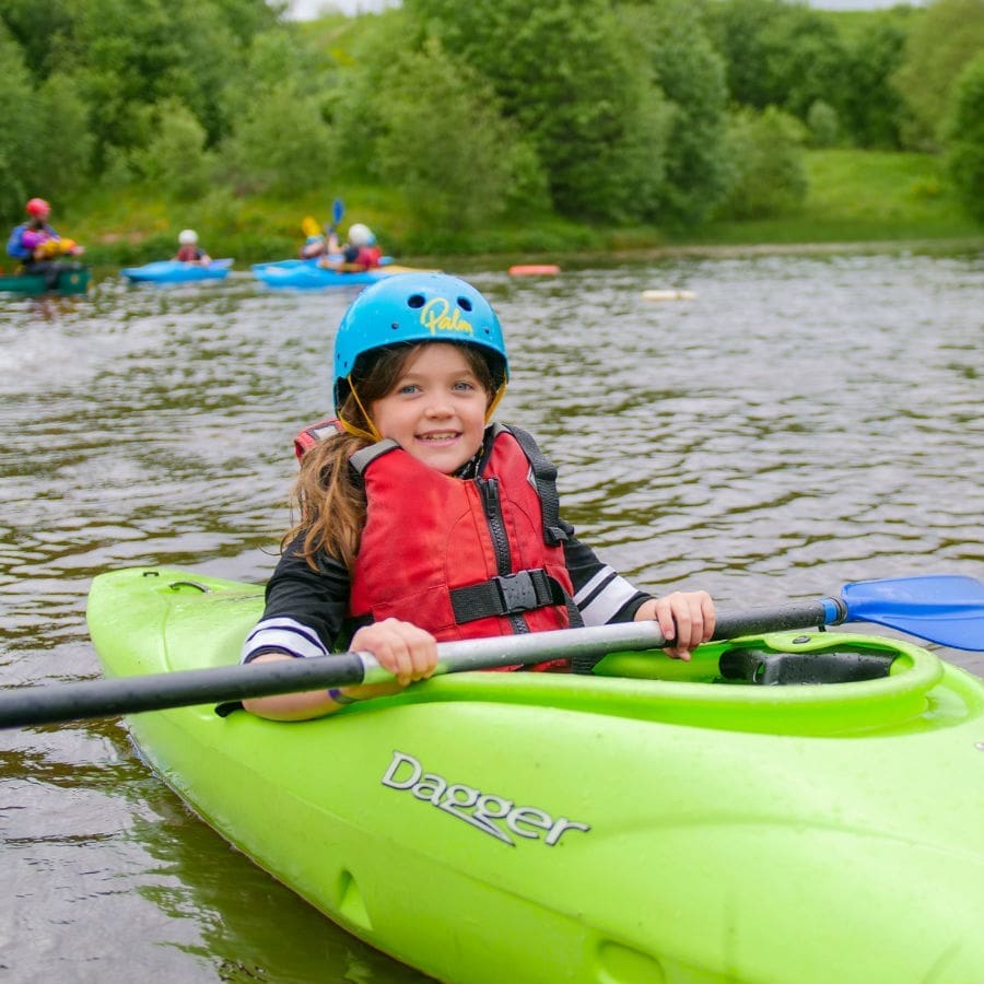 Girl smiling and kayaking Girl smiling and kayaking
